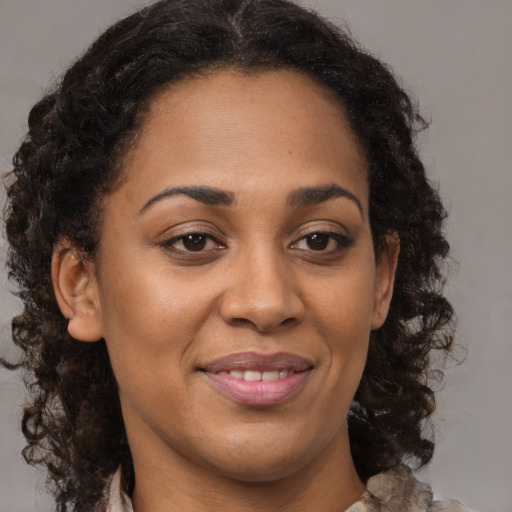 Joyful black adult female with medium  brown hair and brown eyes