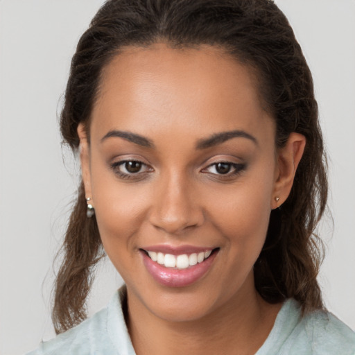 Joyful white young-adult female with long  brown hair and brown eyes