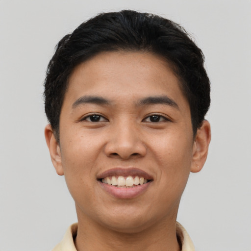 Joyful asian young-adult male with short  brown hair and brown eyes