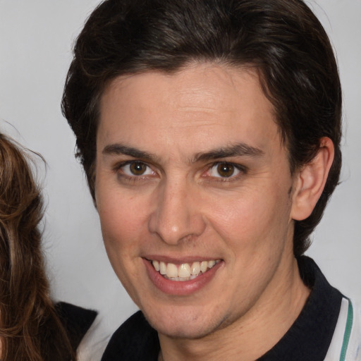 Joyful white adult female with medium  brown hair and brown eyes