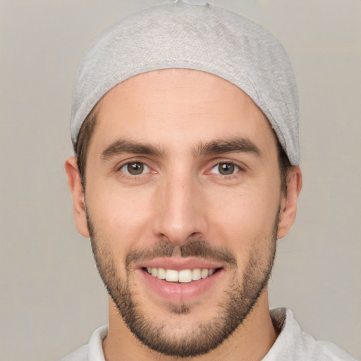 Joyful white young-adult male with short  black hair and brown eyes