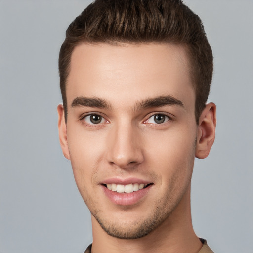 Joyful white young-adult male with short  brown hair and brown eyes