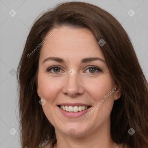 Joyful white adult female with long  brown hair and brown eyes