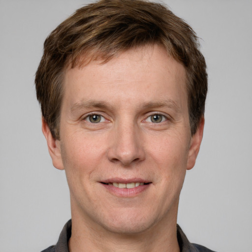 Joyful white adult male with short  brown hair and grey eyes