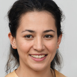 Joyful white young-adult female with medium  brown hair and brown eyes