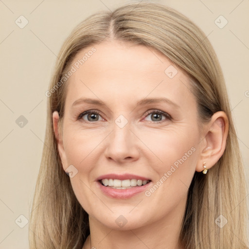 Joyful white adult female with long  brown hair and grey eyes