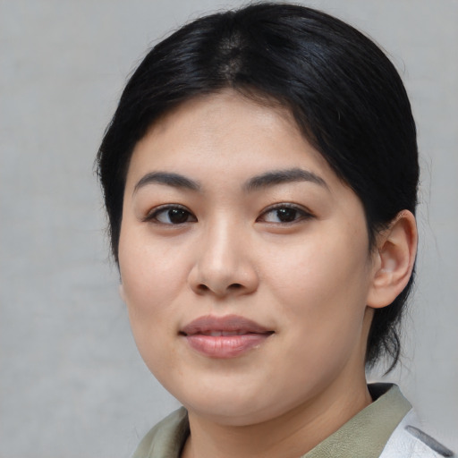 Joyful asian young-adult female with medium  black hair and brown eyes