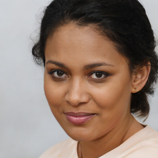 Joyful black young-adult female with medium  brown hair and brown eyes
