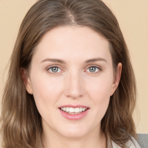 Joyful white young-adult female with medium  brown hair and grey eyes