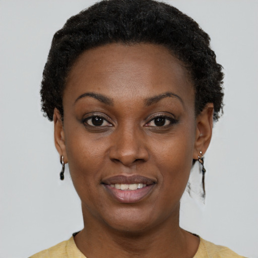 Joyful black young-adult female with short  brown hair and brown eyes