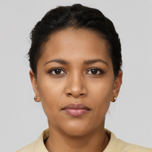 Joyful latino young-adult female with short  black hair and brown eyes