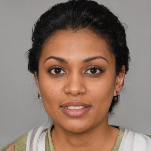 Joyful latino young-adult female with short  black hair and brown eyes