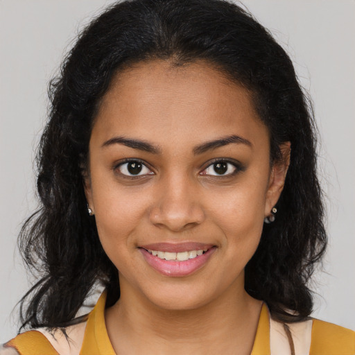 Joyful latino young-adult female with medium  brown hair and brown eyes