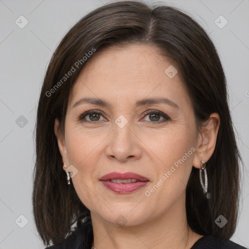 Joyful white adult female with medium  brown hair and grey eyes