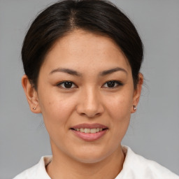 Joyful asian young-adult female with medium  brown hair and brown eyes