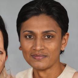 Joyful asian adult female with medium  brown hair and brown eyes