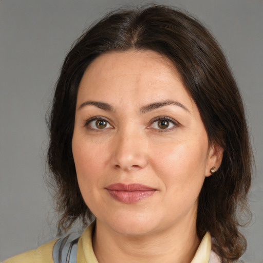 Joyful white adult female with medium  brown hair and brown eyes