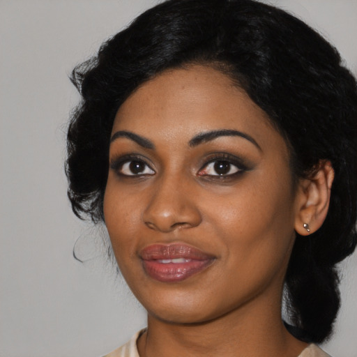 Joyful black young-adult female with medium  black hair and brown eyes