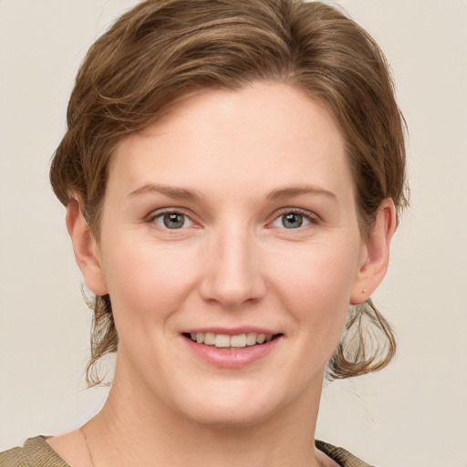 Joyful white young-adult female with medium  brown hair and grey eyes