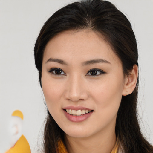 Joyful asian young-adult female with long  brown hair and brown eyes