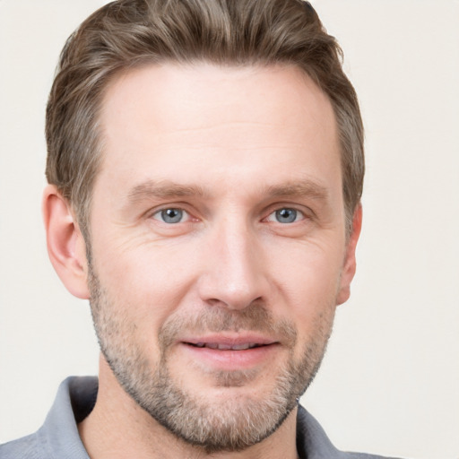 Joyful white adult male with short  brown hair and grey eyes