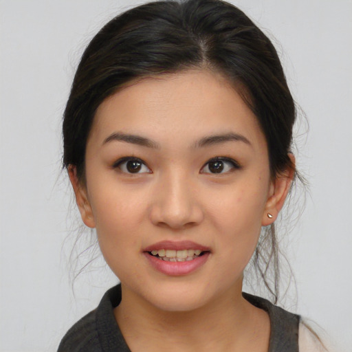 Joyful asian young-adult female with medium  brown hair and brown eyes