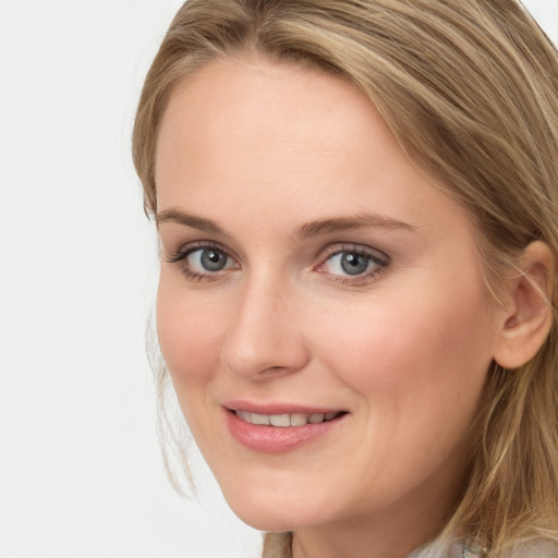 Joyful white young-adult female with long  brown hair and blue eyes