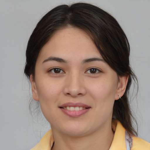 Joyful latino young-adult female with medium  brown hair and brown eyes