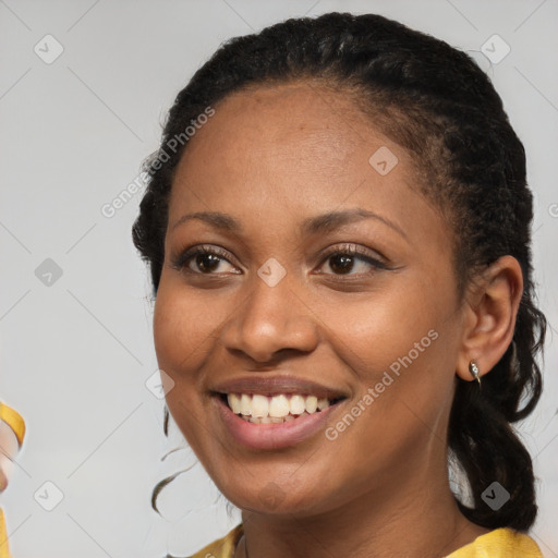 Joyful black young-adult female with short  brown hair and brown eyes