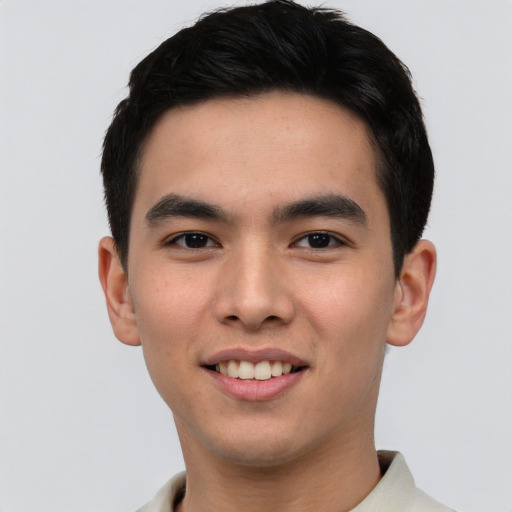 Joyful white young-adult male with short  black hair and brown eyes