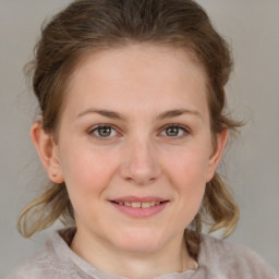 Joyful white young-adult female with medium  brown hair and blue eyes