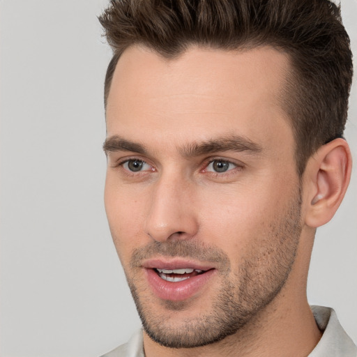 Joyful white young-adult male with short  brown hair and brown eyes