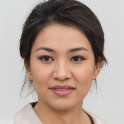 Joyful asian young-adult female with medium  brown hair and brown eyes