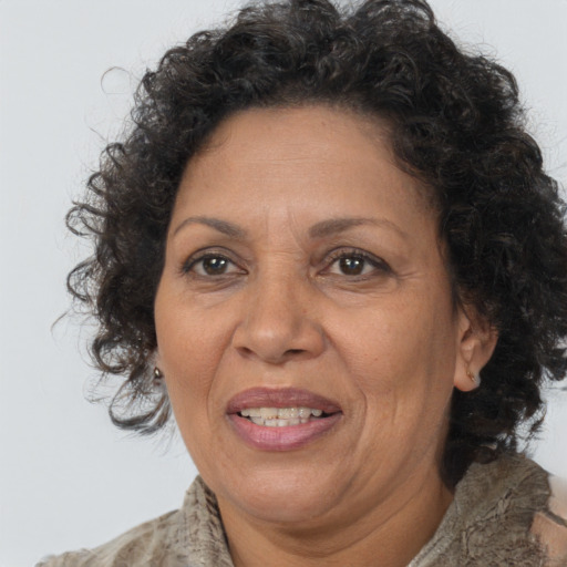 Joyful black adult female with medium  brown hair and brown eyes