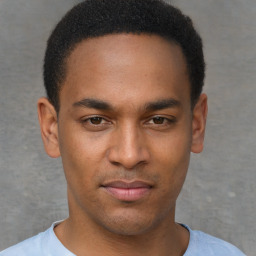 Joyful latino young-adult male with short  brown hair and brown eyes