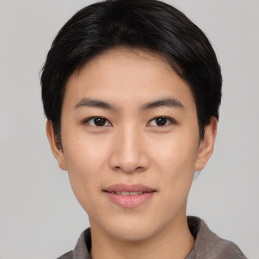 Joyful asian young-adult female with short  black hair and brown eyes