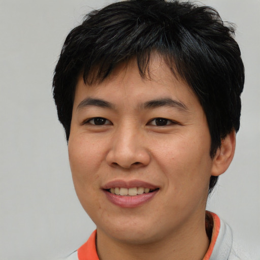Joyful asian young-adult male with short  brown hair and brown eyes
