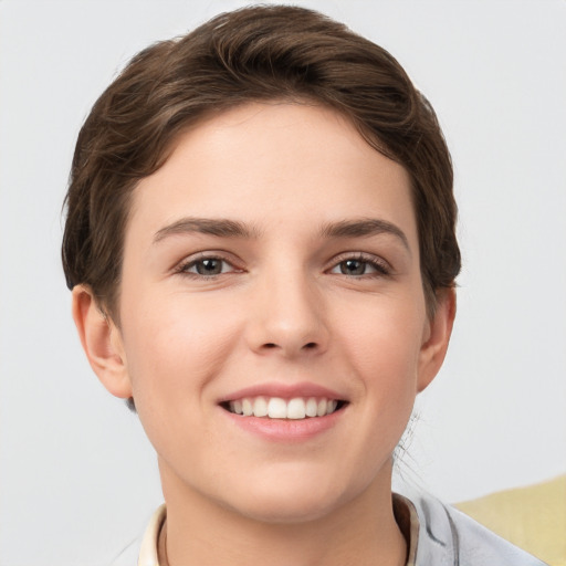 Joyful white young-adult female with short  brown hair and grey eyes