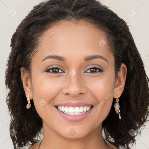 Joyful latino young-adult female with long  brown hair and brown eyes