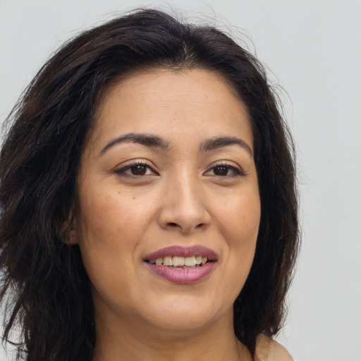 Joyful latino young-adult female with long  brown hair and brown eyes