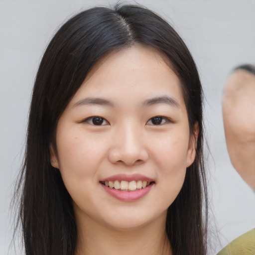 Joyful asian young-adult female with long  brown hair and brown eyes