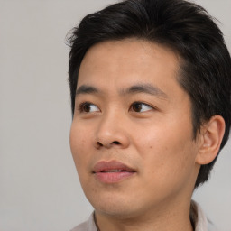 Joyful asian young-adult male with short  black hair and brown eyes