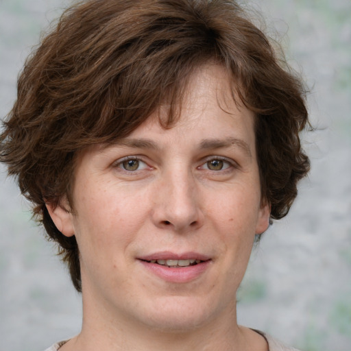 Joyful white adult female with medium  brown hair and grey eyes