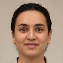 Joyful white young-adult female with medium  brown hair and brown eyes