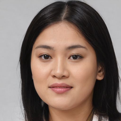 Joyful asian young-adult female with long  black hair and brown eyes