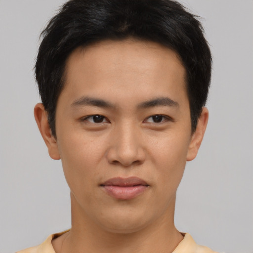 Joyful asian young-adult male with short  brown hair and brown eyes