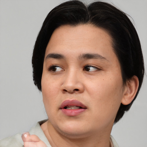 Joyful asian young-adult male with medium  black hair and brown eyes