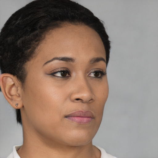 Joyful black young-adult female with short  brown hair and brown eyes