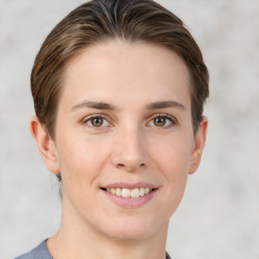 Joyful white young-adult female with short  brown hair and grey eyes