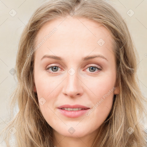 Joyful white young-adult female with long  brown hair and blue eyes